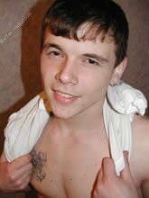 Tatted-up twink shows off in front of a camera