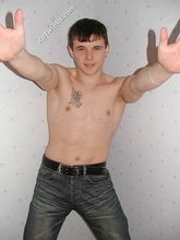 Tatted-up twink shows off in front of a camera