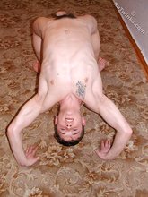 Young boy sucking on his own toes and doing bridges