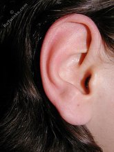 Long-haired twink happily jerking off on a couch