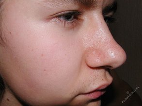 Long-haired twink happily jerking off on a couch