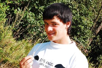 Dark-haired young twink posing in a haystack