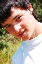 Dark-haired young twink posing in a haystack
