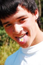 Dark-haired young twink posing in a haystack