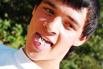 Dark-haired young twink posing in a haystack