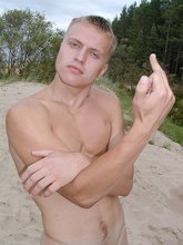 Jacked-up blond-haired stud flips you off outdoors