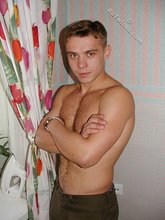 Jacked-up twink posing shirtless by the wall
