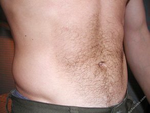 Jacked-up twink posing shirtless by the wall