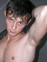 Slender twink posing shirtless in a ruined apartment