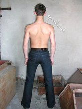 Slender twink posing shirtless in a ruined apartment