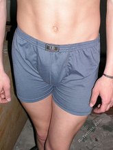 Slender twink posing shirtless in a ruined apartment
