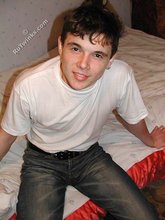 Dark-haired twink shows his feet, his socks, his smile