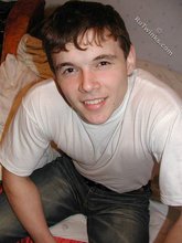 Dark-haired twink shows his feet, his socks, his smile