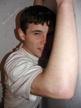 Dark-haired twink shows his feet, his socks, his smile