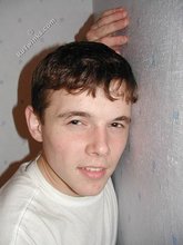 Dark-haired twink shows his feet, his socks, his smile