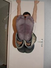 Dark-haired twink shows his feet, his socks, his smile