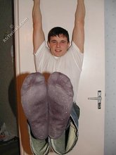 Dark-haired twink shows his feet, his socks, his smile