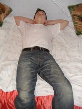 Dark-haired twink shows his feet, his socks, his smile