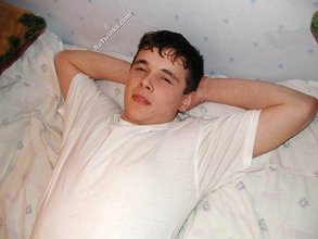 Dark-haired twink shows his feet, his socks, his smile