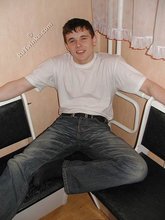 Dark-haired twink shows his feet, his socks, his smile