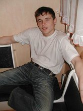 Dark-haired twink shows his feet, his socks, his smile