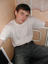 Dark-haired twink shows his feet, his socks, his smile