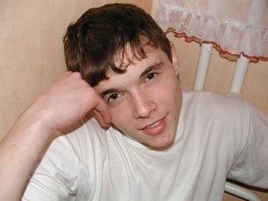 Dark-haired twink shows his feet, his socks, his smile