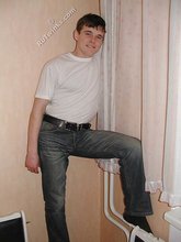 Dark-haired twink shows his feet, his socks, his smile
