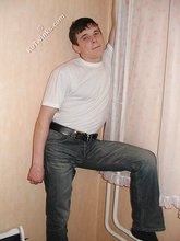 Dark-haired twink shows his feet, his socks, his smile