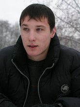 Dark-haired young Russian twink posing outdoors