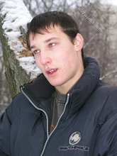 Dark-haired young Russian twink posing outdoors