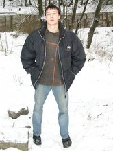 Dark-haired young Russian twink posing outdoors