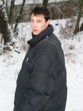 Dark-haired young Russian twink posing outdoors