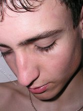 Dark-haired young boy flashes his delicious ass up close