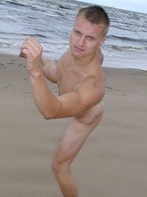 Blond-haired twink happily posing by the water