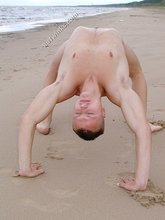 Blond-haired twink happily posing by the water