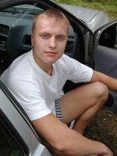 Blond-haired twink happily posing by the water