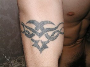 Tatted-up twink with a hairy cock showing his body