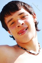 Dark-haired twink posing in the sun, looking sexy