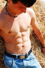 Dark-haired twink posing in the sun, looking sexy