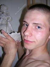 Kinky bald-headed twink putting his clothes back on