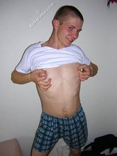 Kinky bald-headed twink putting his clothes back on