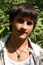 Dark-haired young boy shows off his ass and then some