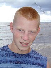 Muscly redheaded twink posing by the river