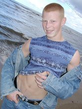 Muscly redheaded twink posing by the river