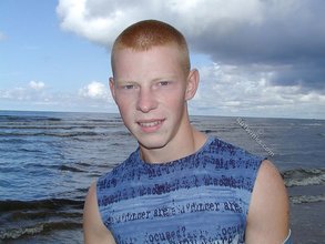Muscly redheaded twink posing by the river