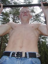 Jacked-up twink doing pull-ups and posing seductively