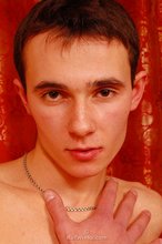 Dark-haired young boy grabbing his cock, aggressively