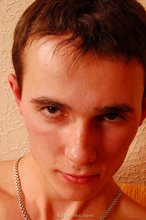 Dark-haired young boy grabbing his cock, aggressively