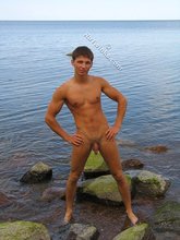 Tanned twink decides to pose naked by the river